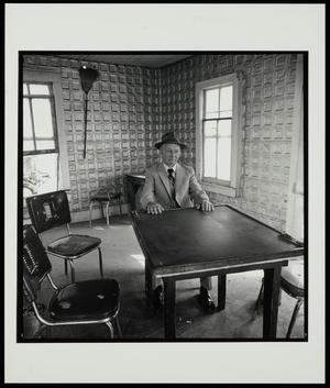 Primary view of object titled '[Man sitting at a table in Myra, Texas]'.