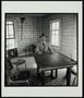 Primary view of [Man sitting at a table in Myra, Texas]