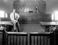 Photograph: [Doyle Willis sitting in a court room]