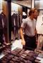 Photograph: [Mike Modano standing by suits in a men's shop]