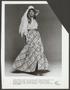Photograph: [A woman posing in a voille shirt and flounced skirt]