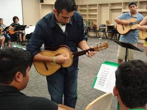Primary view of object titled '[2013 Mariachi Aguilitas camp student plays the vihuela]'.