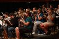 Photograph: [Trombone players sitting behind bass clarinetists]