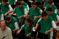 Photograph: [Rows of percussionists in green shirts performing onstage, 7]