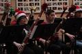 Photograph: [Two rows of people playing bassoons adorned with tinsel, 4]