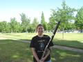 Photograph: [A woman in a black t-shirt posing with a bassoon]