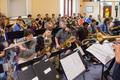 Thumbnail image of item number 1 in: '[Rows of woodwind and brass musicians performing in a room, 2]'.