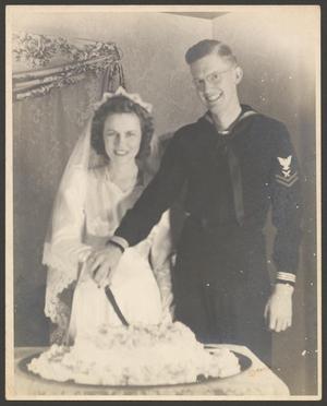 Primary view of object titled '[Newlyweds cutting their cake]'.
