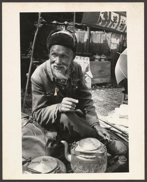 Primary view of object titled '[An elder man with a few tea kettles]'.