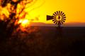 Photograph: [Tranquil Sunset Reflections: A Windmill Serenade on Lake Amistad]