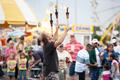 Photograph: [People enjoying the juggling show at the East Texas State Fair]