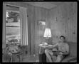 Thumbnail image of item number 1 in: '[Shirtless man in a wood-paneled room]'.