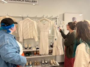 Primary view of object titled '[Students examining garments]'.