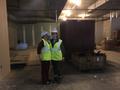 Photograph: [Janelle McCabe and Becker standing in a construction zone]