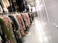 Photograph: [Multiple clothing racks with Texas Fashion Collection garments, 2]