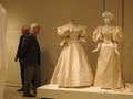 Photograph: [Winn Morton looking at historic wedding dresses]