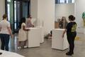 Photograph: [Staff placing pedestals at the entrance to the exhibition]