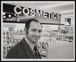 Photograph: [A man in a store's cosmetics department]