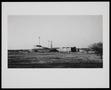 Photograph: [Distant view of a complex with a windmill]