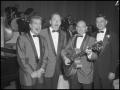 Photograph: [Singing Group Chuck A Lucks posing with the Host, December 7, 1957]