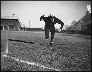 Primary view of object titled '[Football Player Running on the Field]'.