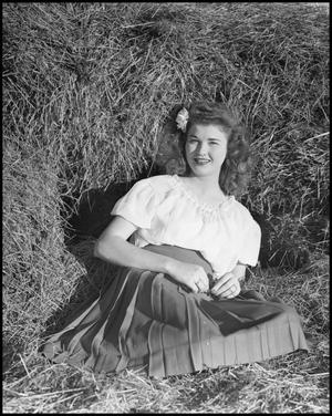 Primary view of object titled '[Virginia Haug seated on straw, 2]'.