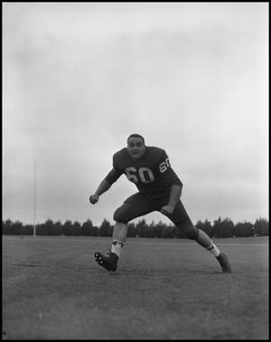 Primary view of object titled '[Football Player No. 60 Running on the Field, September 1962]'.