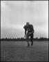Photograph: [Football Player No. 61 Running on the Field, September 1962]