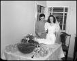 Primary view of [Bride and Groom with Wedding Cake]