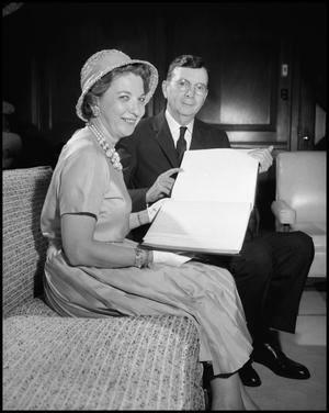 Primary view of object titled '[Dr. Matthews and Mrs. Myrtle Hollander with Book]'.
