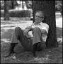 Photograph: [Dr. Wayne Adams sitting beneath a tree, 2]