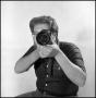 Photograph: [Lewis Abernathy posing for portrait with camera]