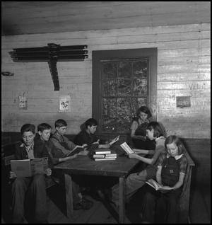 Primary view of object titled '[Students reading at table]'.