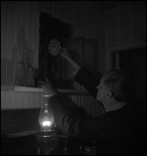 Primary view of object titled '[Setting the clock by oil lamp]'.