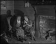 Photograph: [Neighbors Visiting beside the Fire Place in 1942]