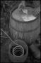 Photograph: [Mixing grain in a barrel, 2]