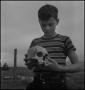 Photograph: [Raymond Clark holding a human skull]