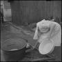 Photograph: [Photo of a woman preparing a pot]