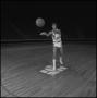Photograph: [Basketball player tossing ball into the air]