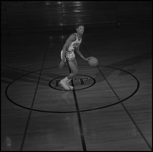 Primary view of object titled '[Willie Gandy dribbling ball on basketball court]'.