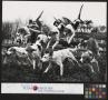 Photograph: [Fox Hounds Leaping over a Rail Fence]