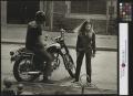 Photograph: [Man, woman, and motorcycle]