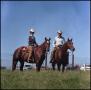 Photograph: [Buster and Sheila Welch on horseback]