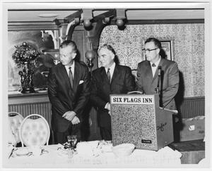 Primary view of [Rex Cauble and two men speaking at a Six Flags Inn event]