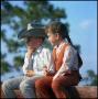 Primary view of [Boy and girl sitting on a fence]