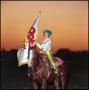 Primary view of [Girl holding a flag rides on horseback]