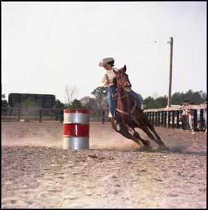 Primary view of object titled '[Woman in yellow shirt barrel racing]'.