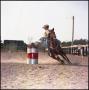 Primary view of [Woman in yellow shirt barrel racing]