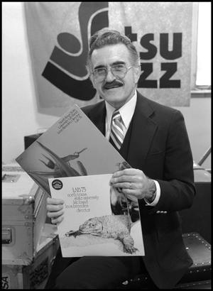 Primary view of object titled '[Leon Breeden holding up Grammy nominated albums]'.