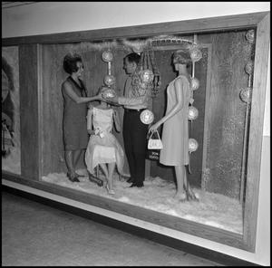Primary view of object titled '[Students adjust decoration in display]'.
